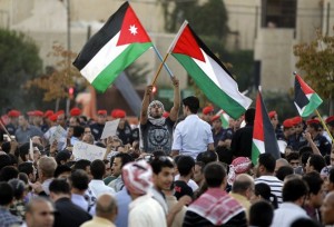 Jordanians wave their national flag and shout slogans during a protest near the Israeli embassy in Amman on September 15, 2011 to demand that the government expel the Jewish state's envoy and scrap the joint 1994 peace treaty. AFP PHOTO/KHALIL MAZRAAWI (Photo credit should read KHALIL MAZRAAWI/AFP/Getty Images)
